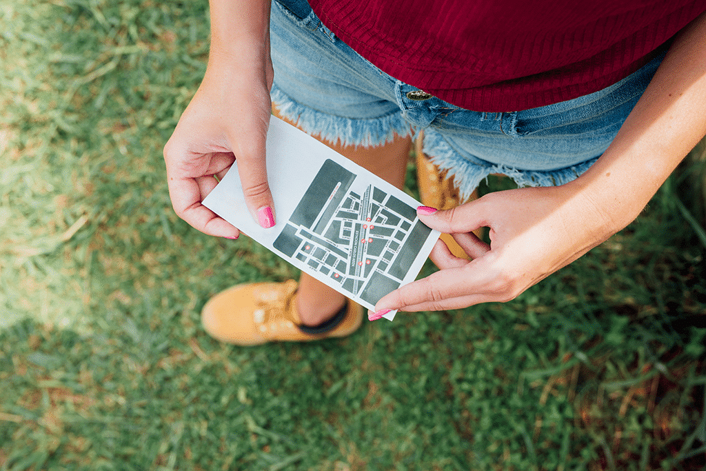 top view woman holding directions card